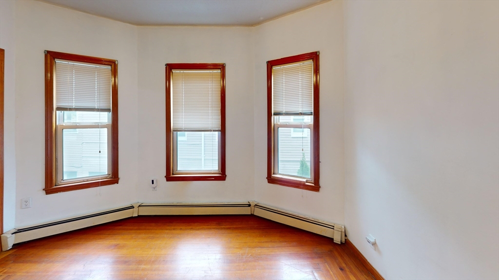 an empty room with windows and closet