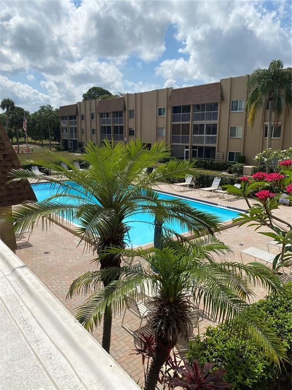 a view of a house with pool and sitting area