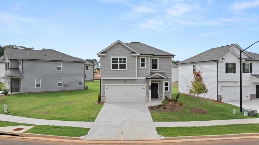 a front view of house with yard and green space