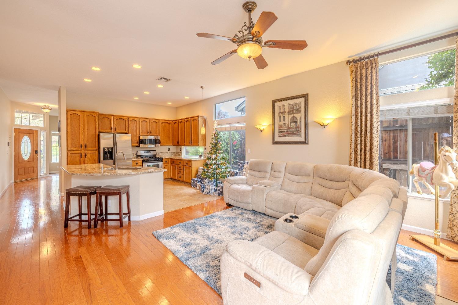 a living room with furniture and kitchen view