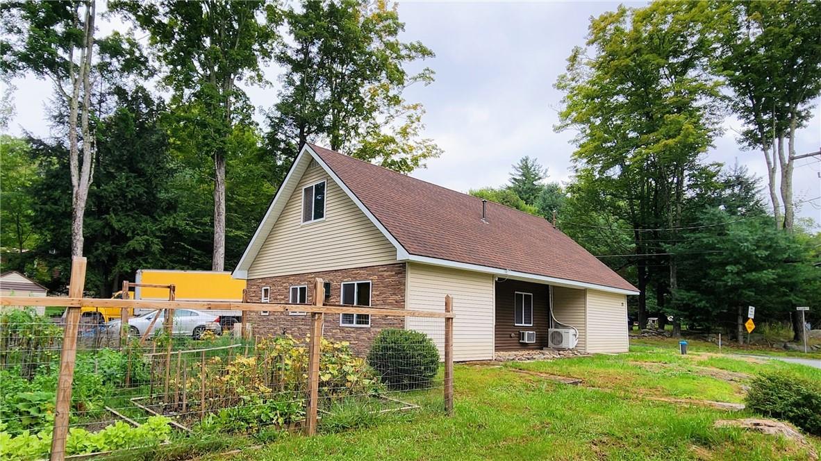 View of side of property with a lawn