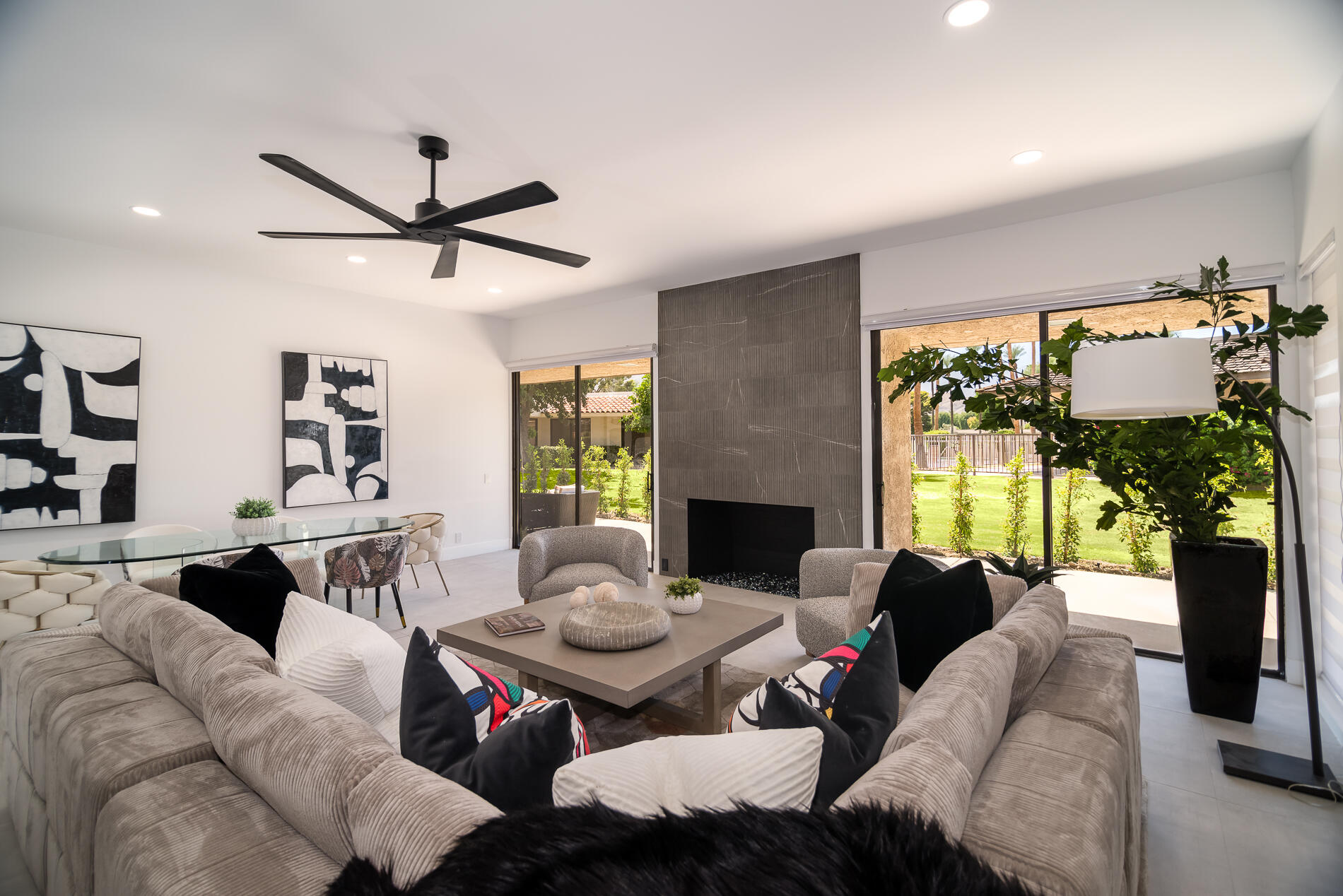 a living room with furniture fireplace and a large window