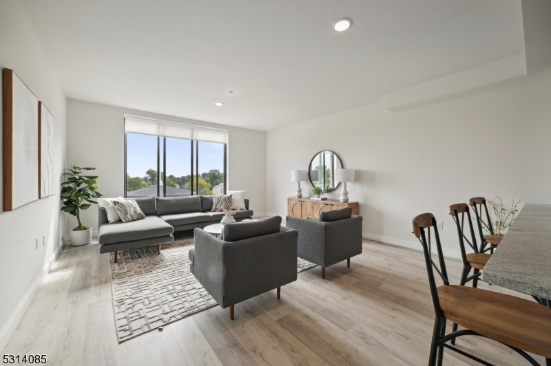 a living room with furniture rug and window