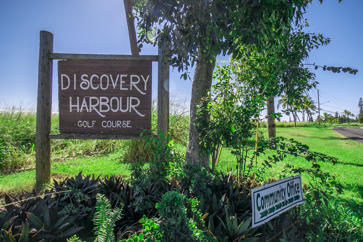 a sign broad in front of flowers