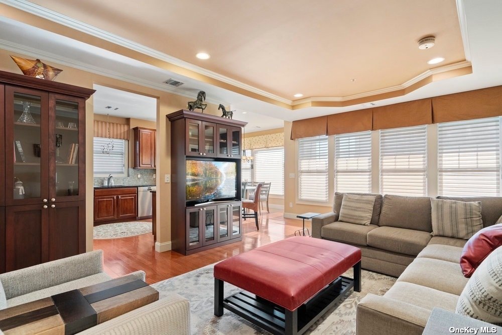 a living room with furniture a flat screen tv and a large window