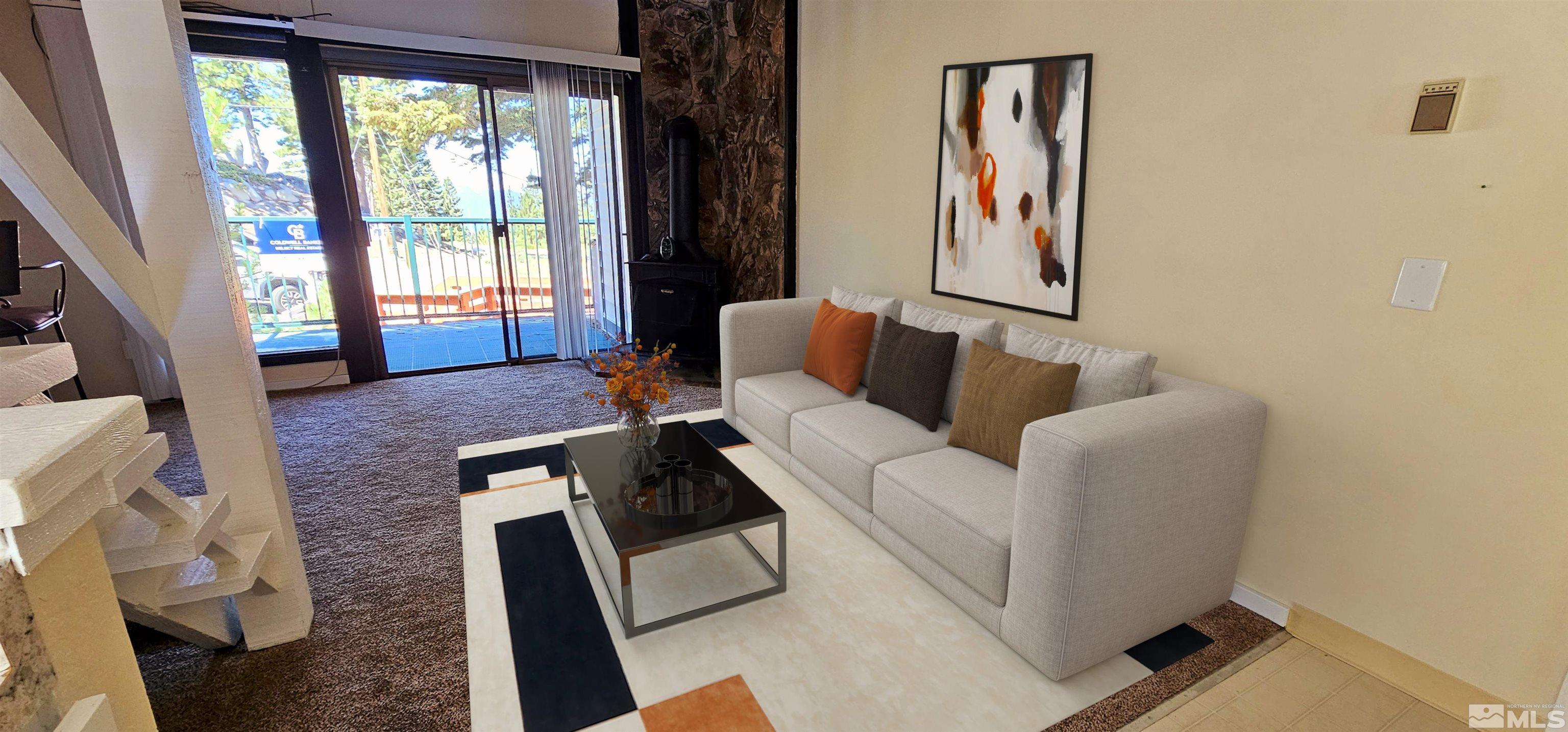 a living room with furniture and a floor to ceiling window