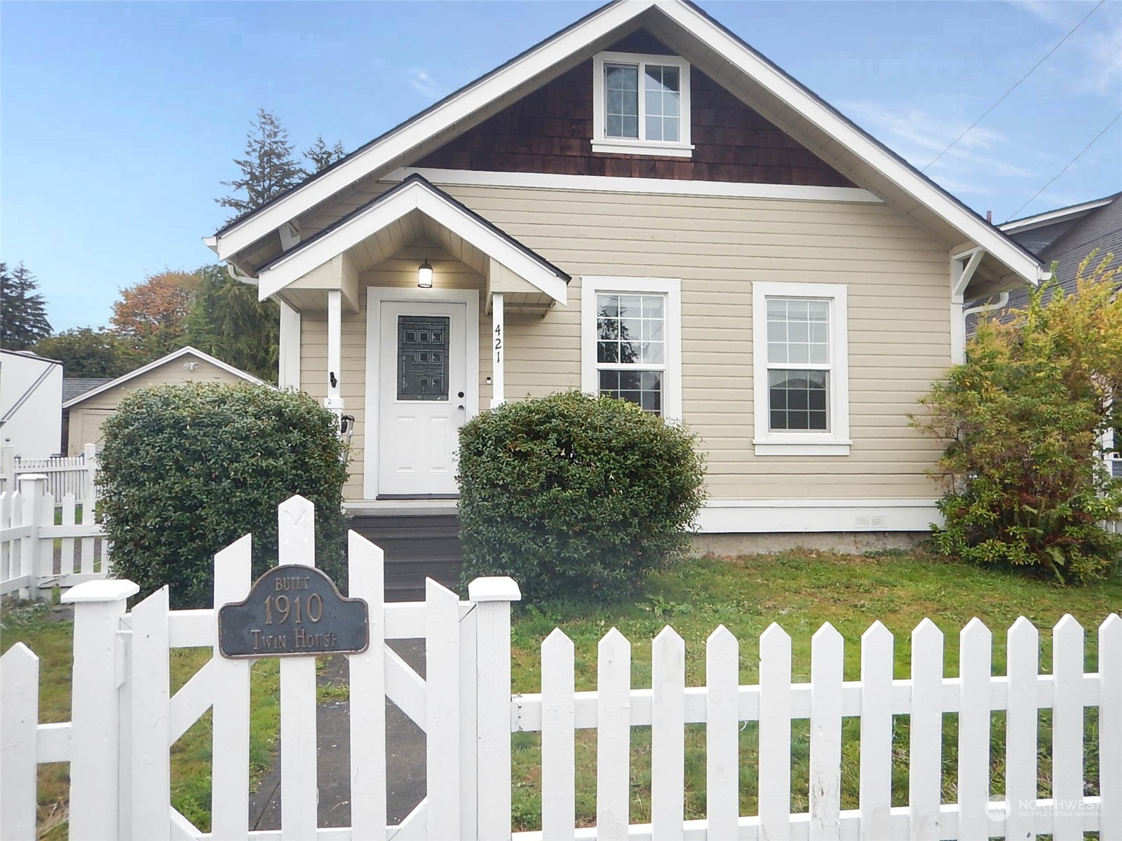 a front view of house with yard and trees