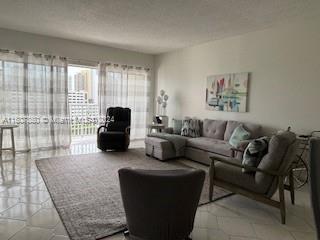 a living room with furniture and large windows