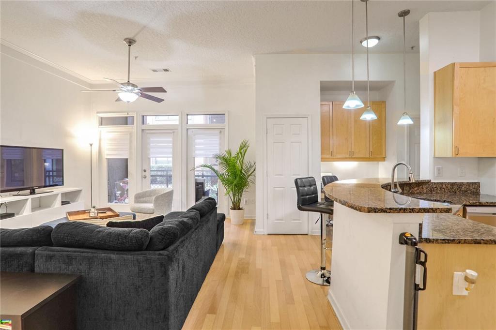 a living room with furniture and a chandelier