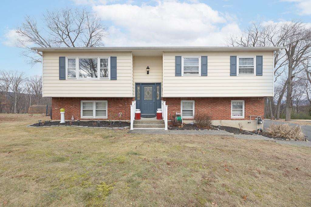 Bi-level home featuring a front lawn