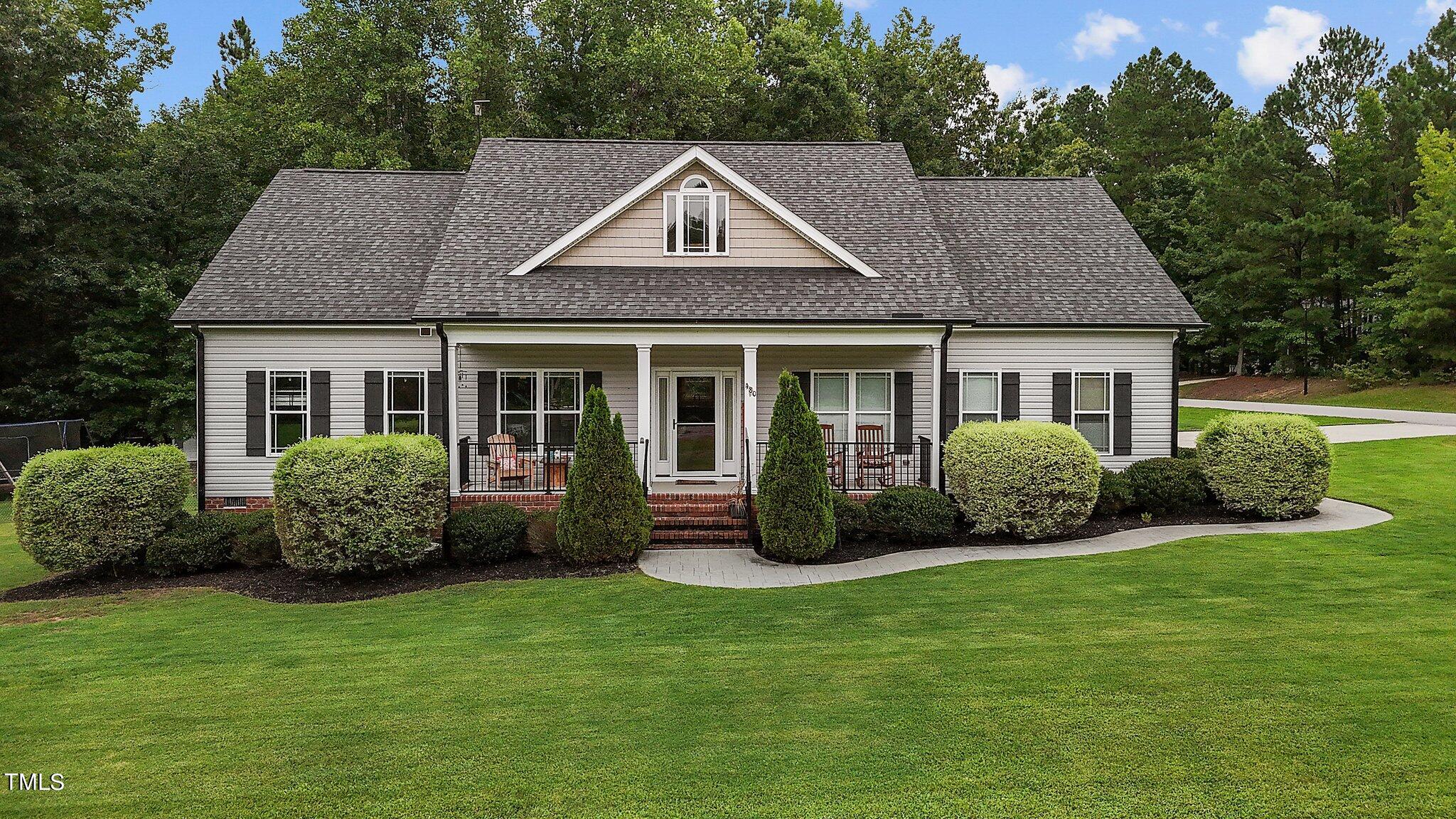 a front view of a house with a garden