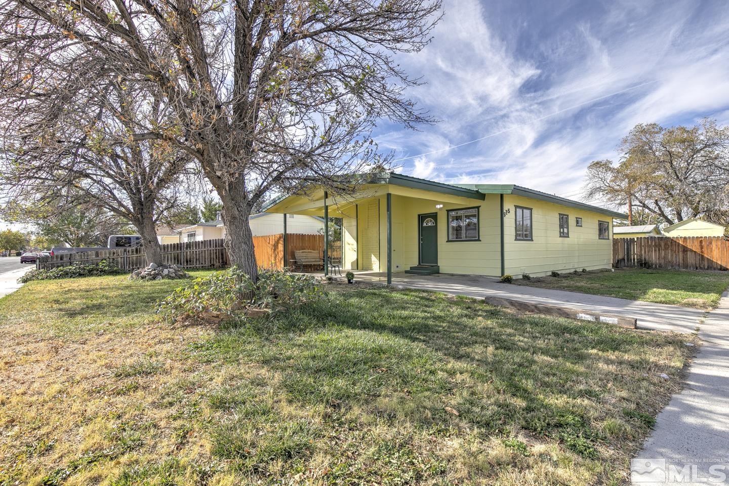 a view of a house with a backyard