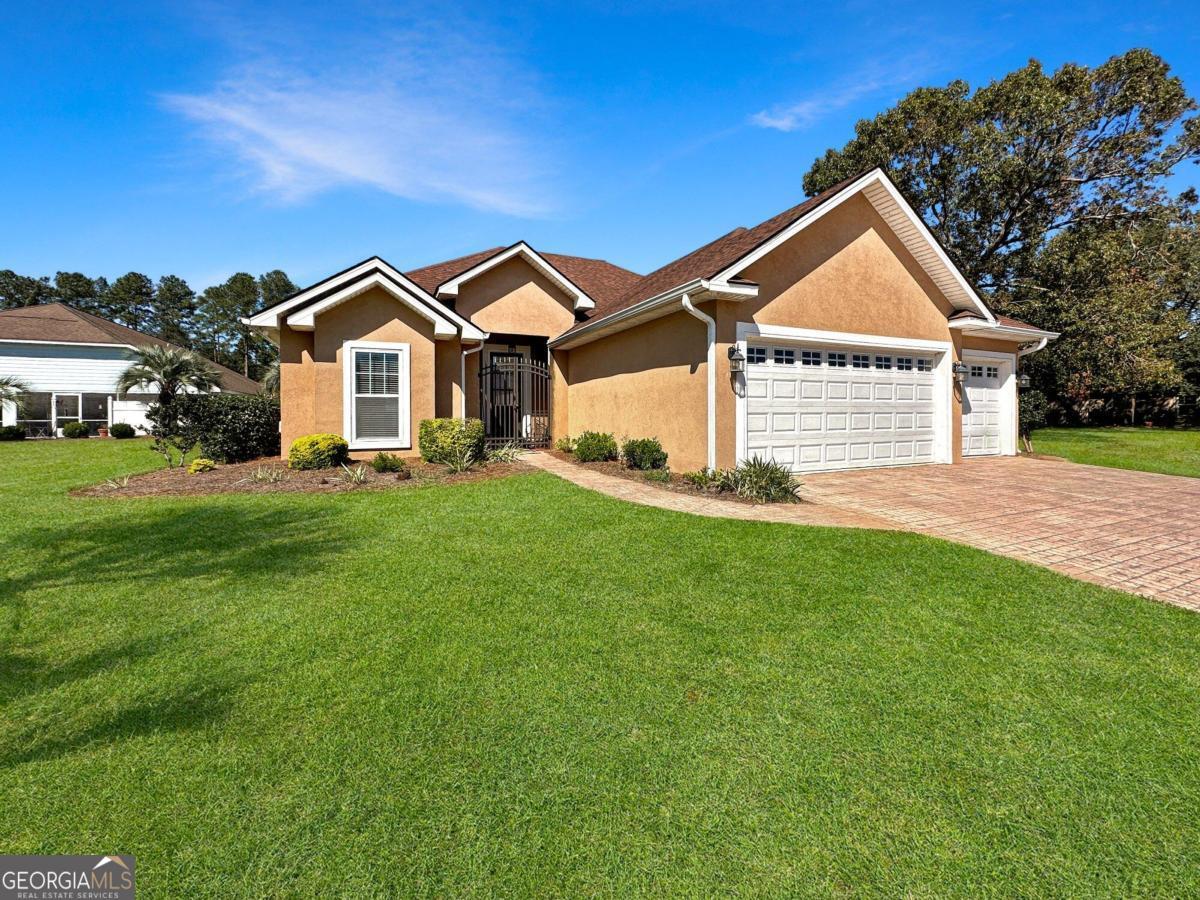 a front view of a house with a yard and garage