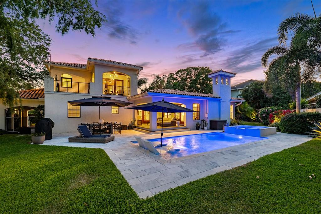 a view of a house with swimming pool yard and sitting area