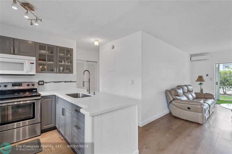 a kitchen with stainless steel appliances granite countertop a sink stove and cabinets