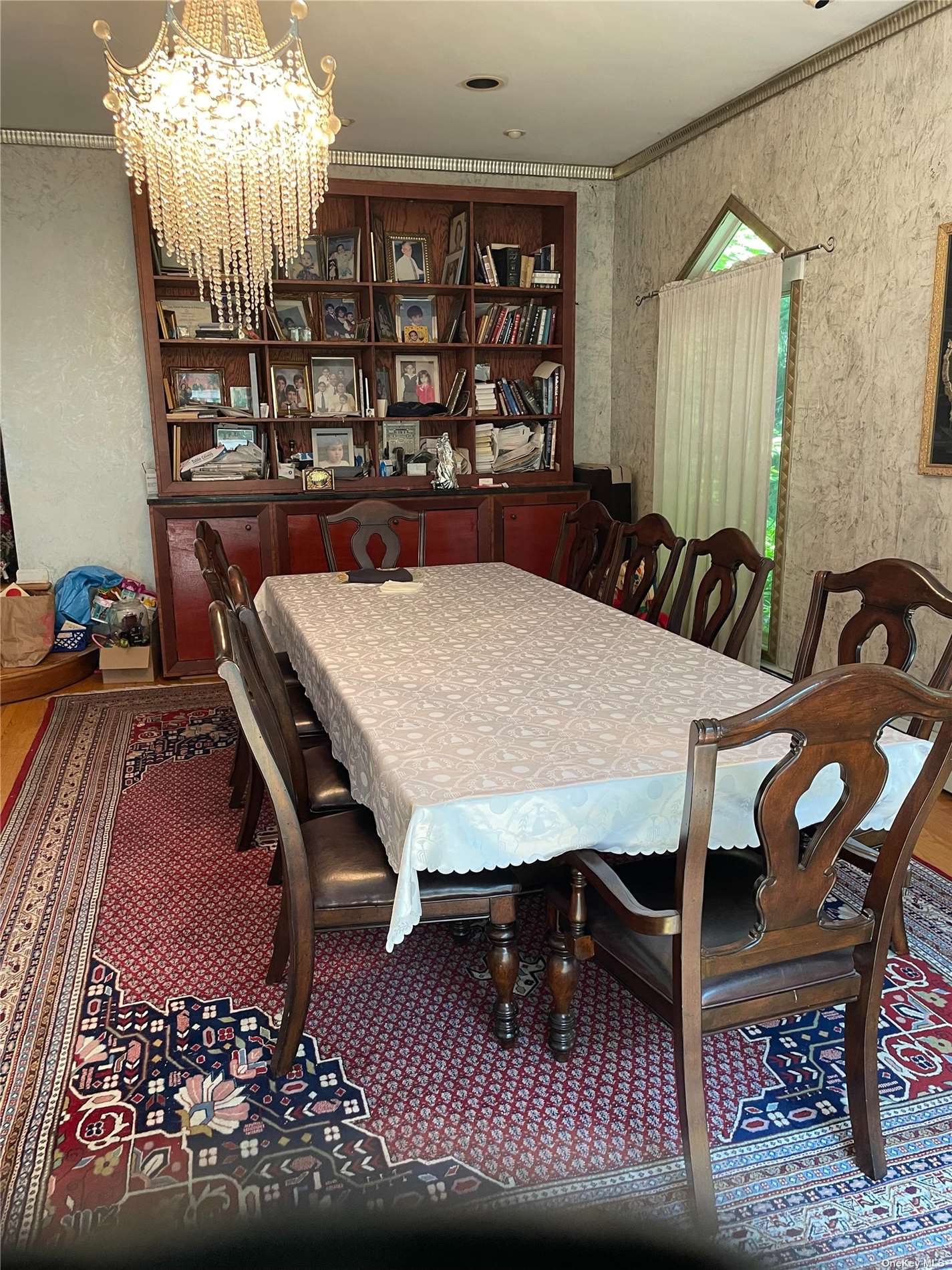 a view of a dining room with furniture and chandelier