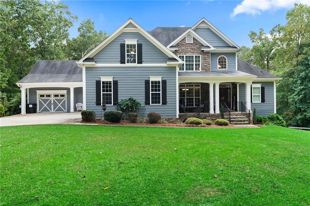 a front view of a house with yard and green space