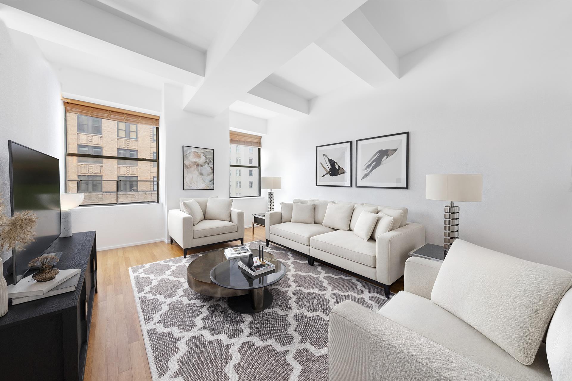 a living room with furniture a flat screen tv and a window