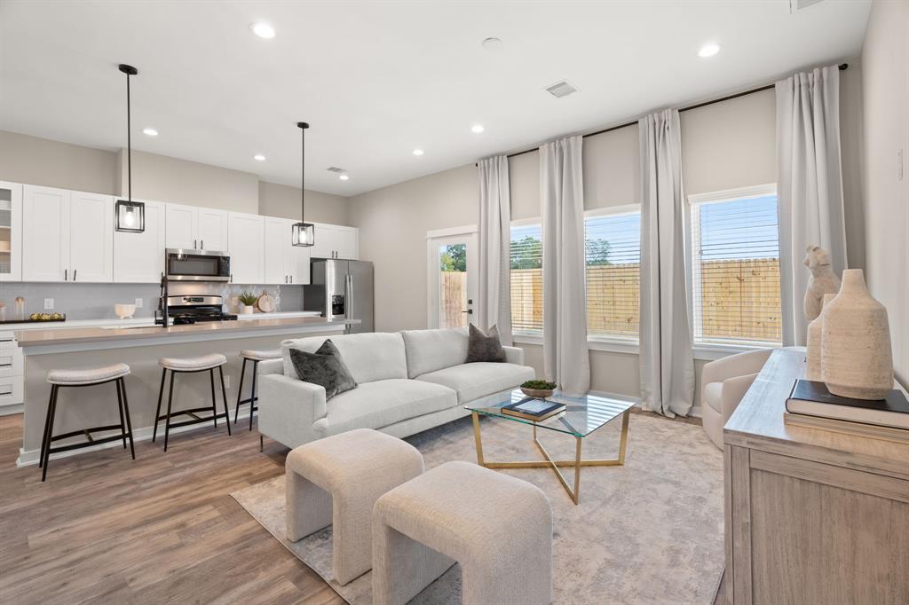 a living room with kitchen island furniture and a large window