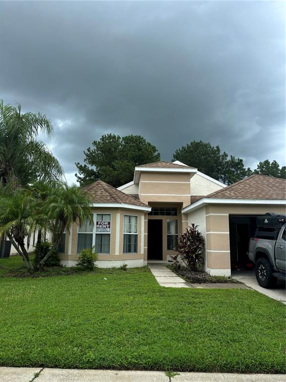 a front view of a house with a garden and trees