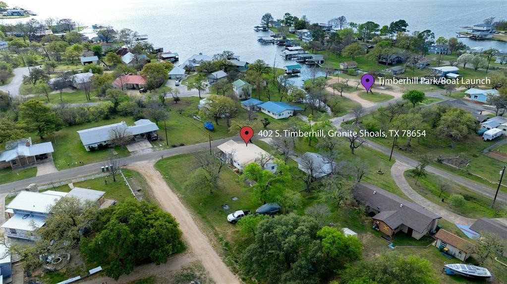 an aerial view of lake residential houses with outdoor space and trees all around