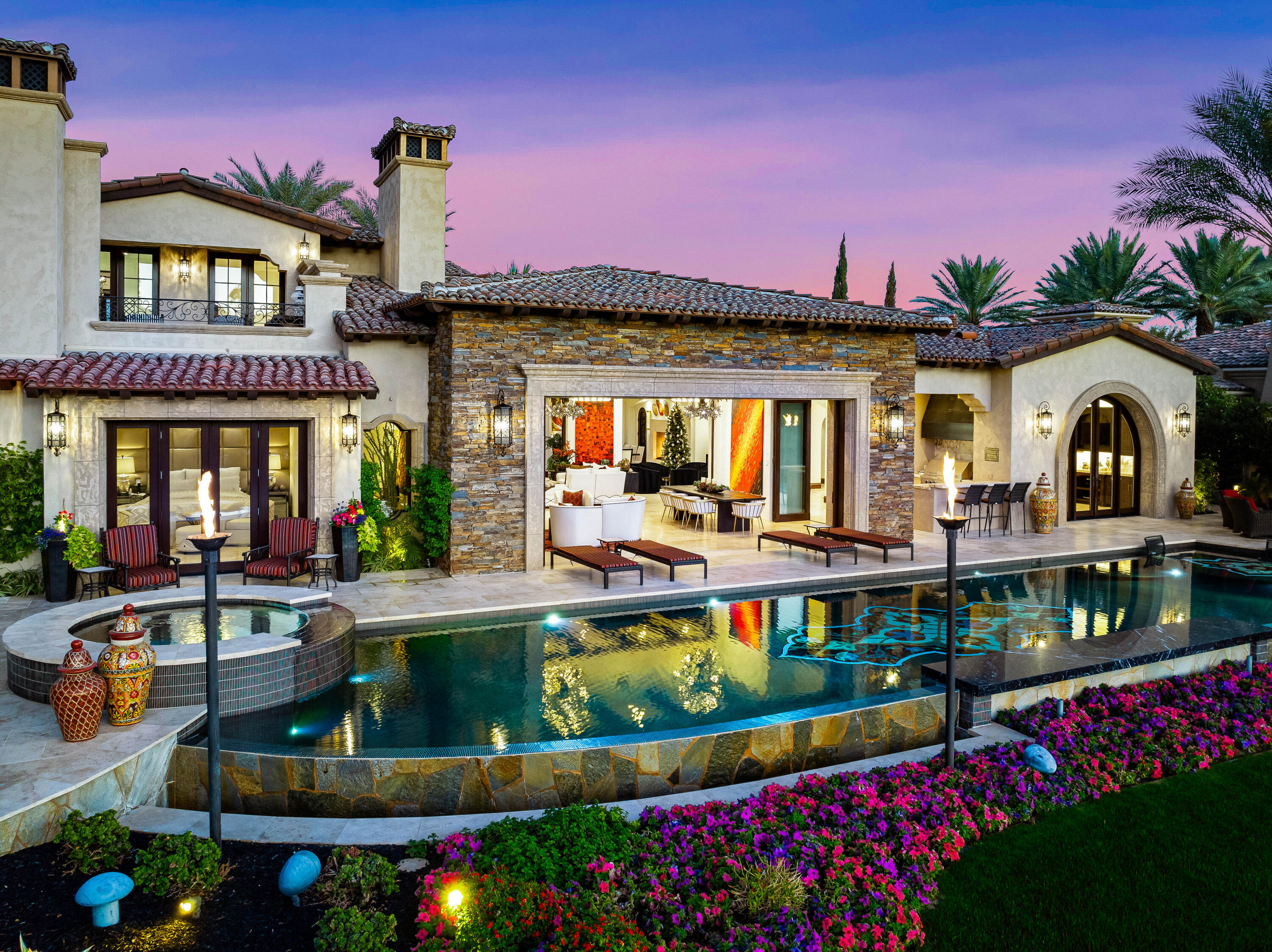 a front view of a house with swimming pool and outdoor seating