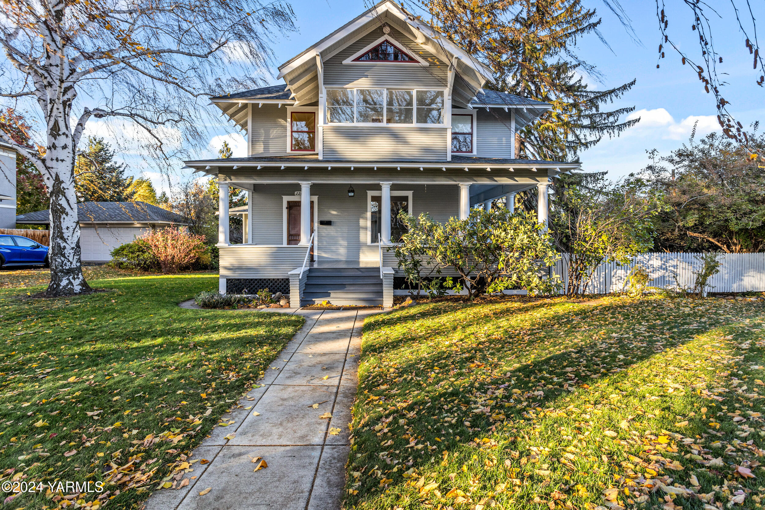 a front view of house with yard and trees around