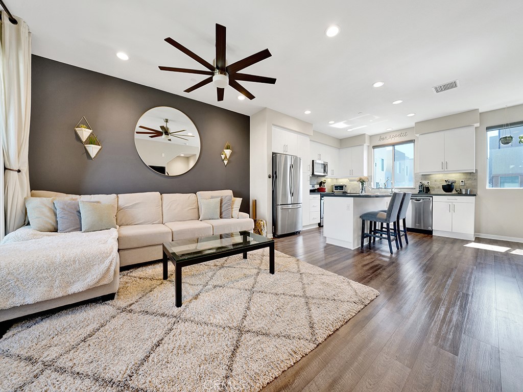 a living room with furniture and kitchen view