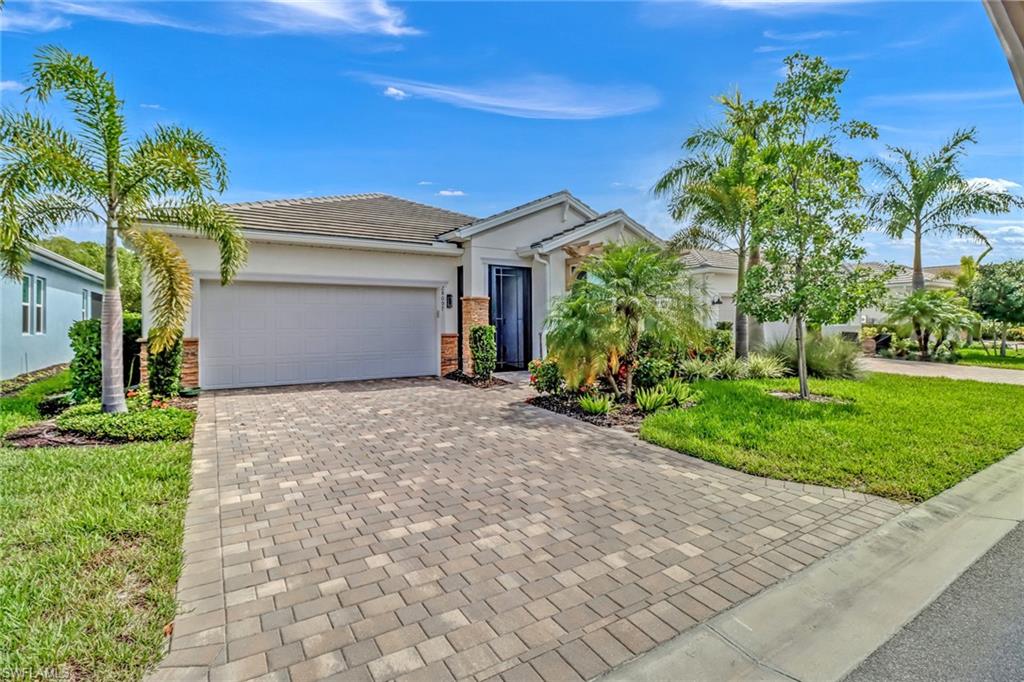 a front view of a house with a yard and a garage