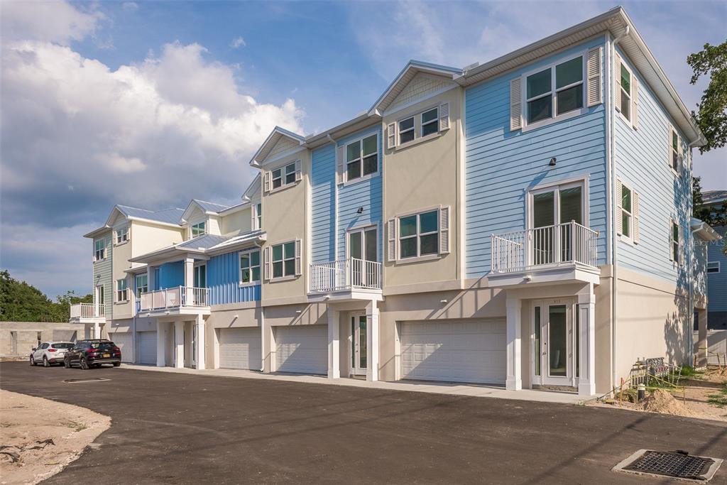 a front view of a residential apartment building with a street