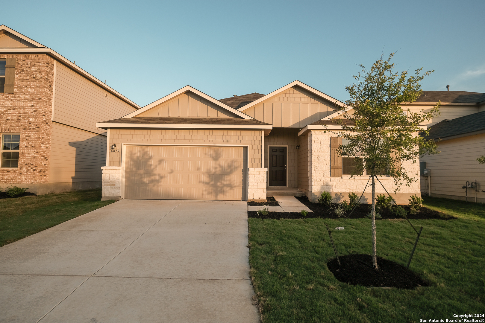 a front view of a house with a yard and fence