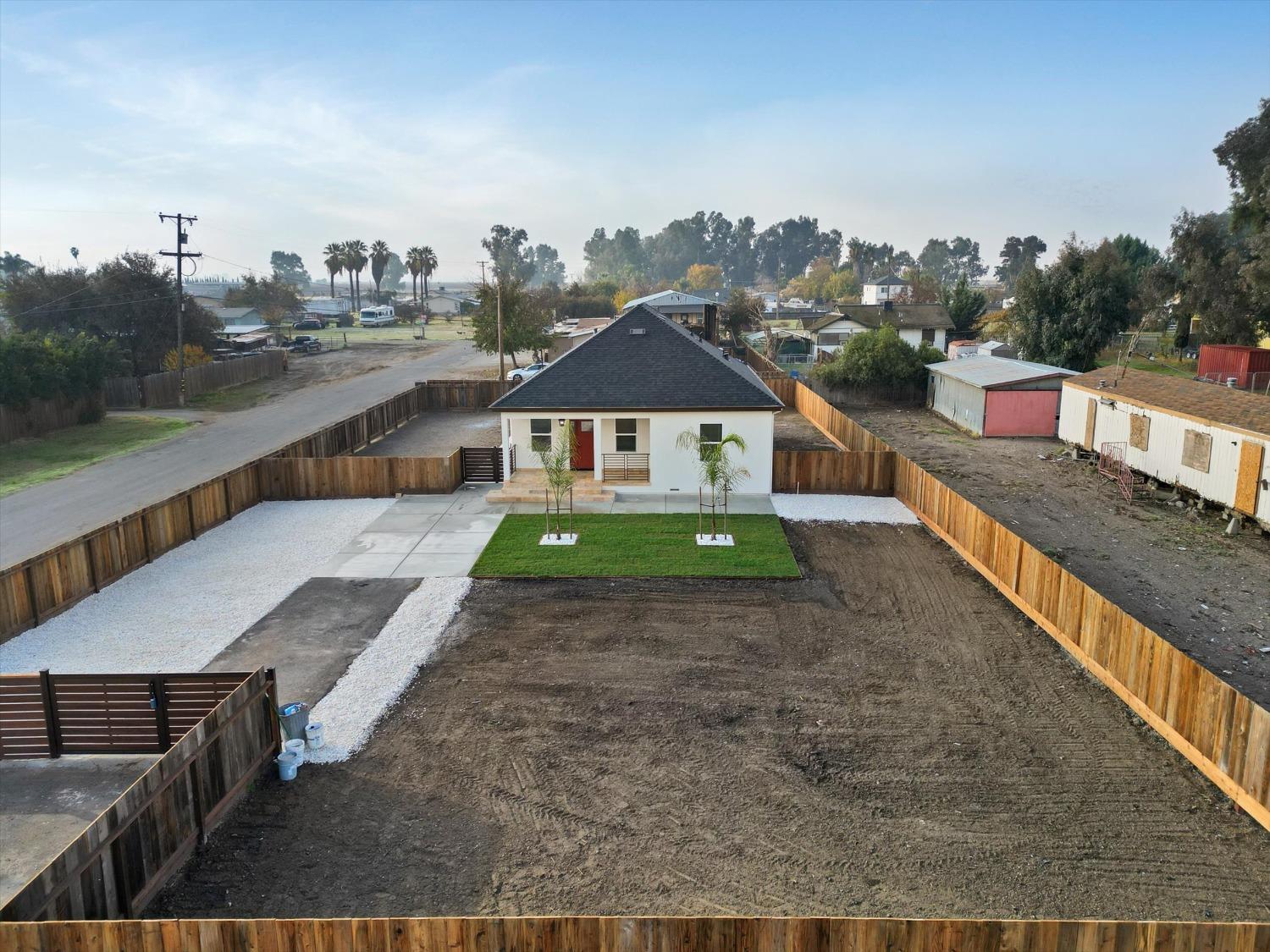 a view of a house with a yard and sitting area