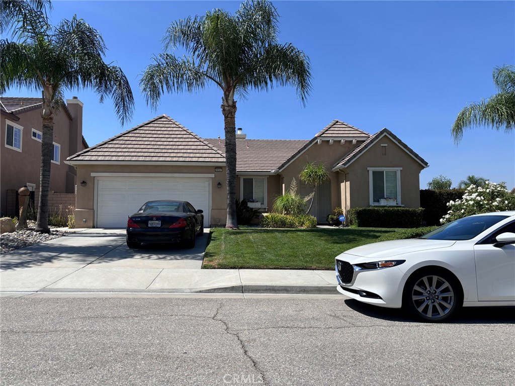 front view of a house with a garden and a yard