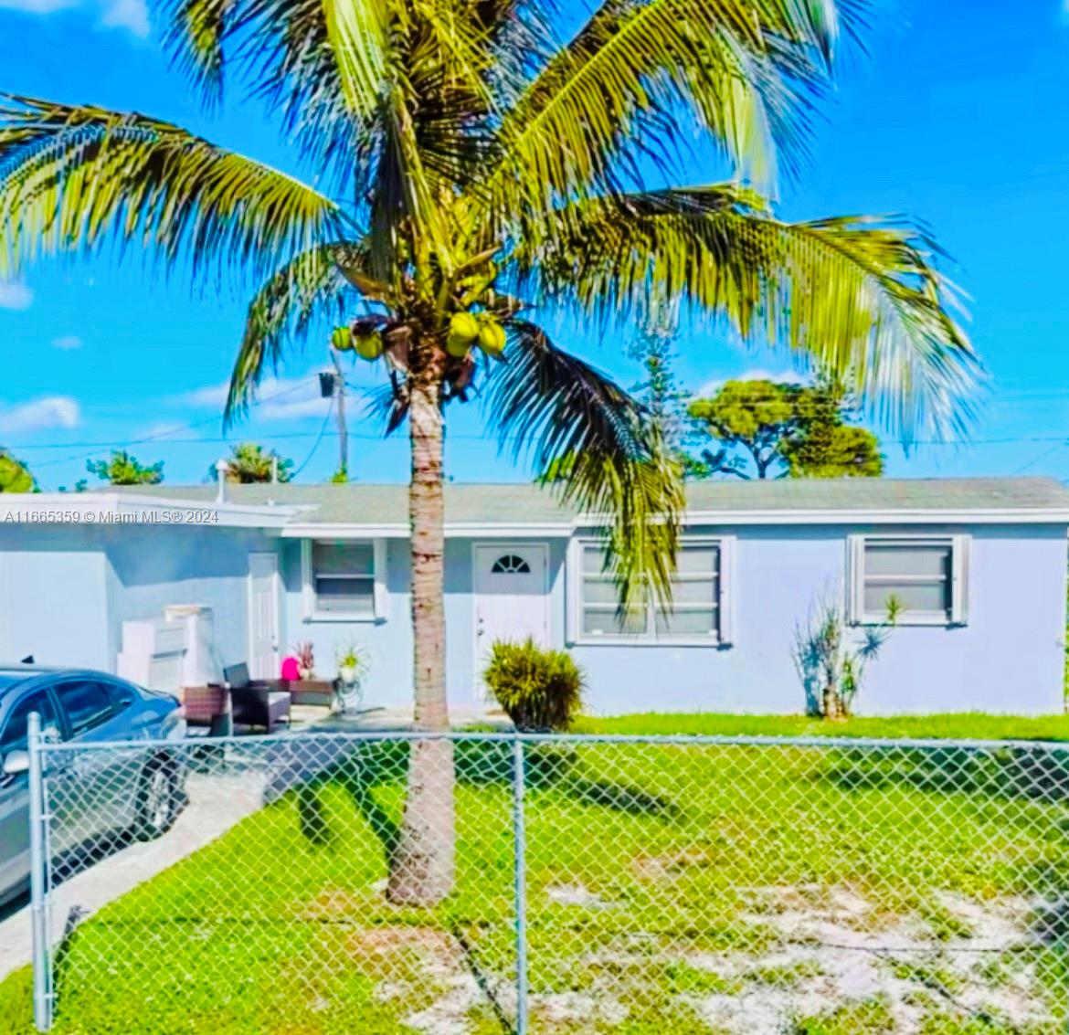 a front view of house with yard and swimming pool