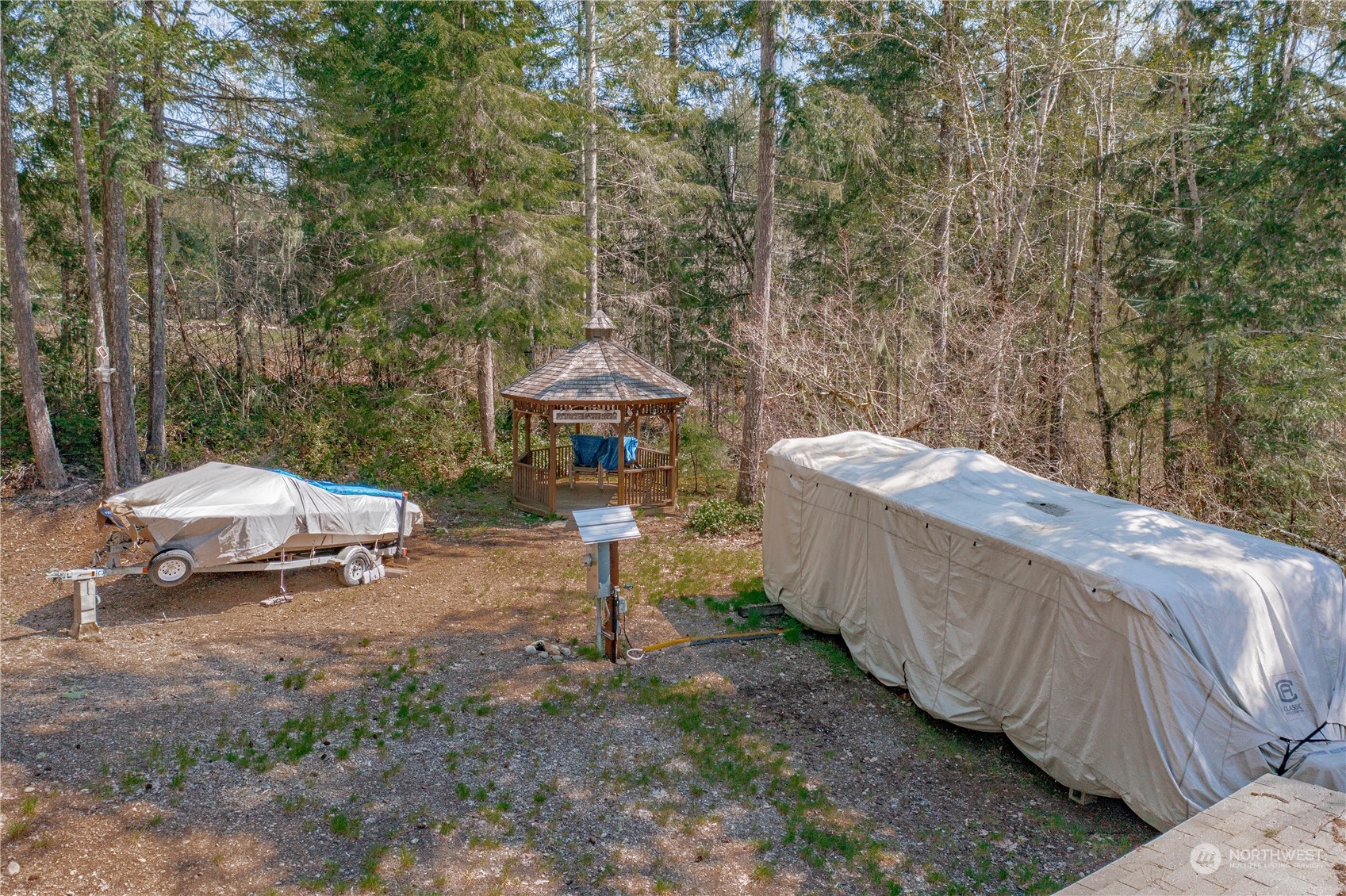 a view of a backyard with a small yard and a fire pit