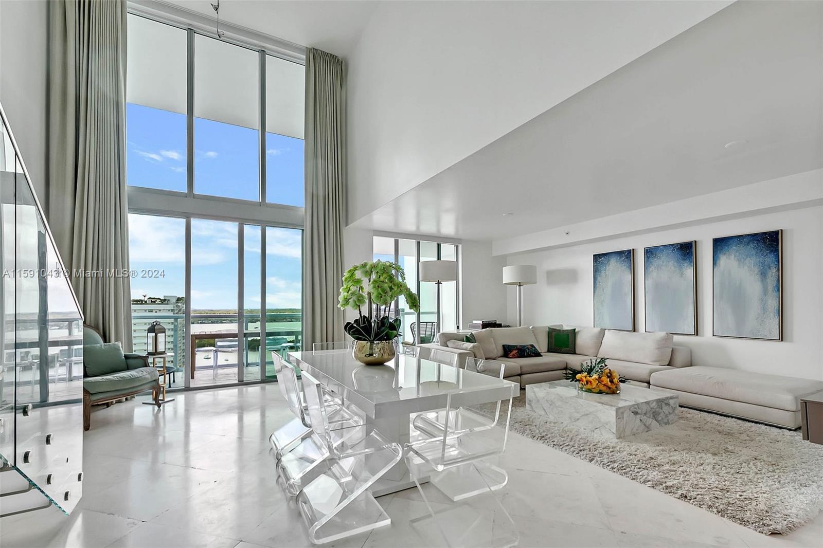 a living room with furniture dining area and a large window