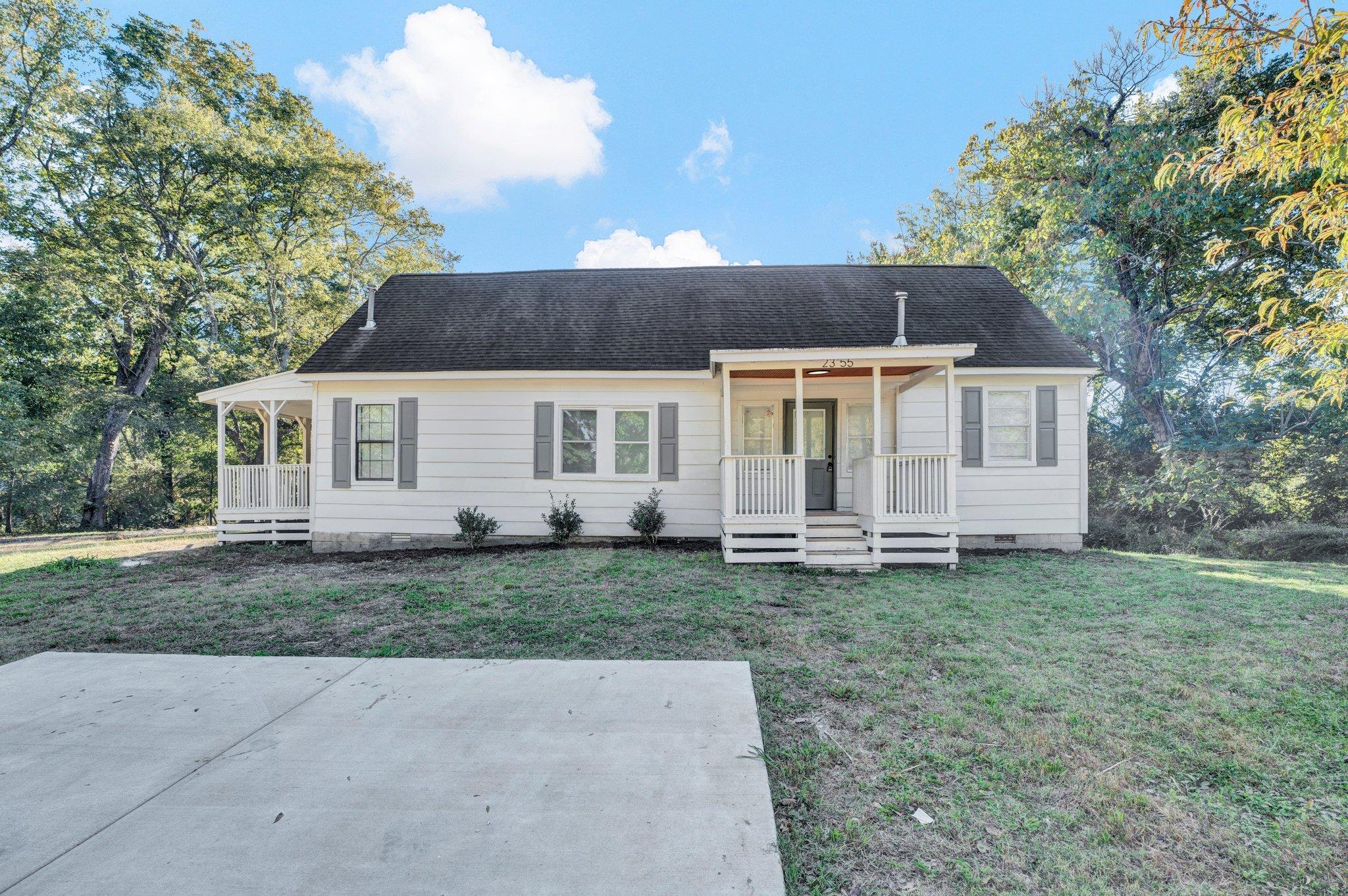 View of front of property with a front yard and a porch