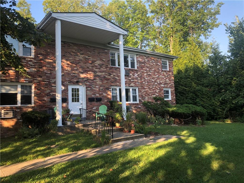 Rear view of property featuring a yard