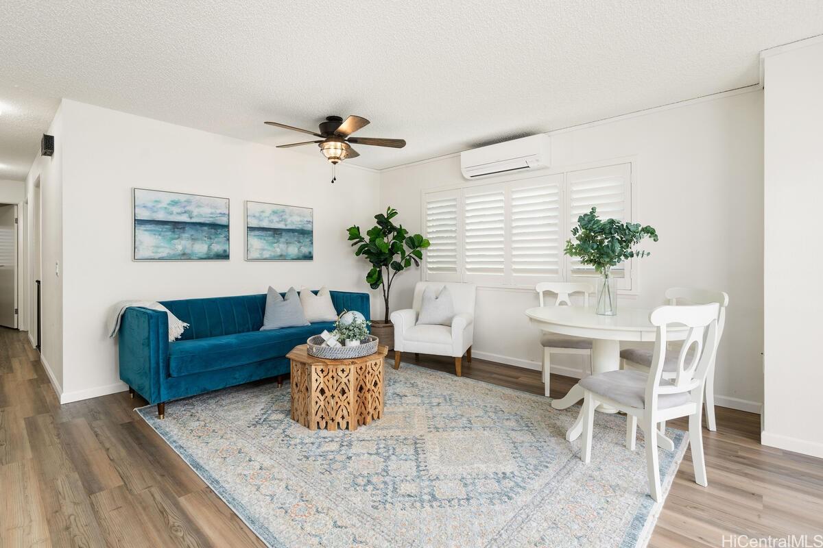 a living room with furniture and a potted plant