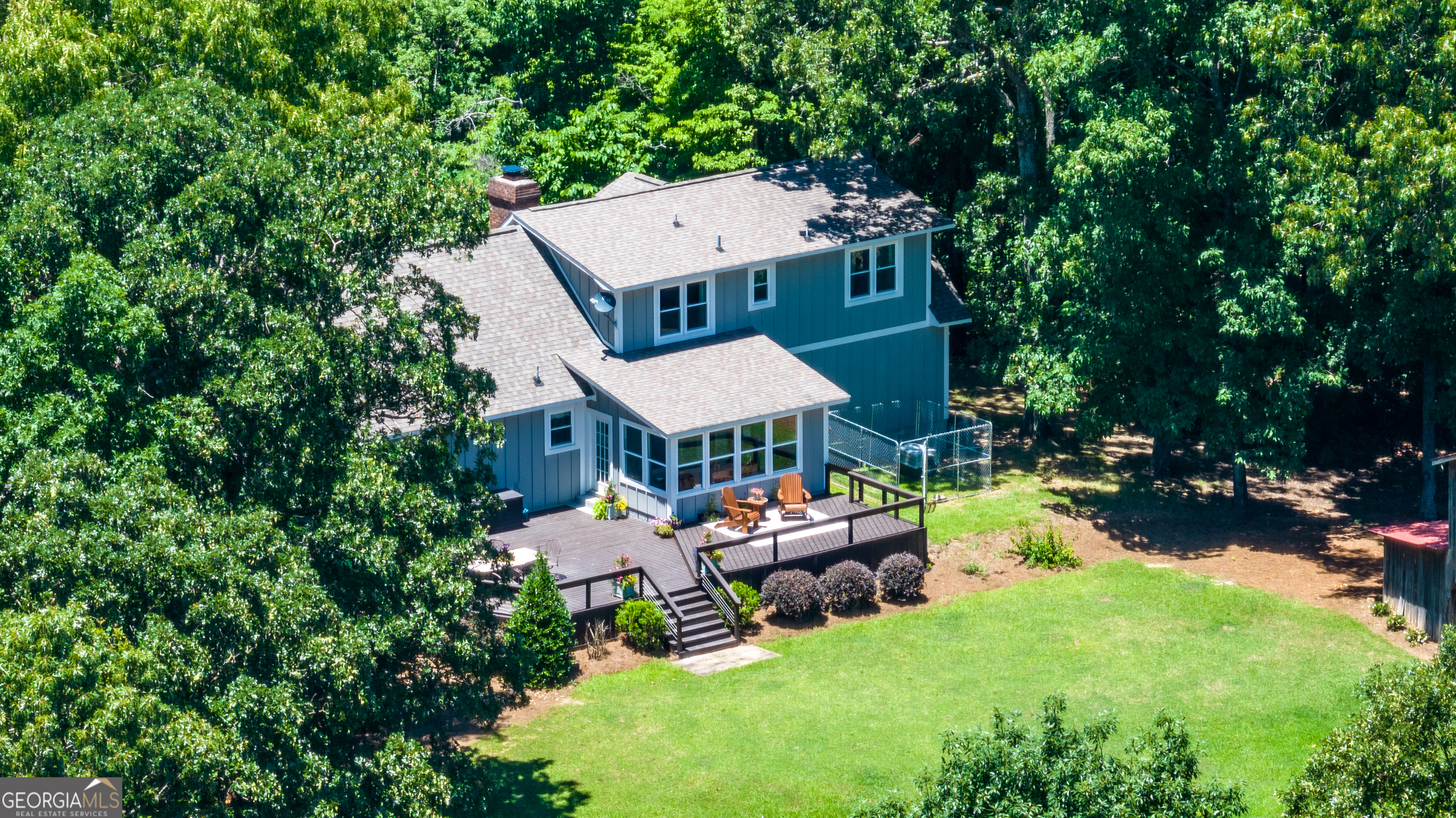 an aerial view of a house with swimming pool garden view and a chairs