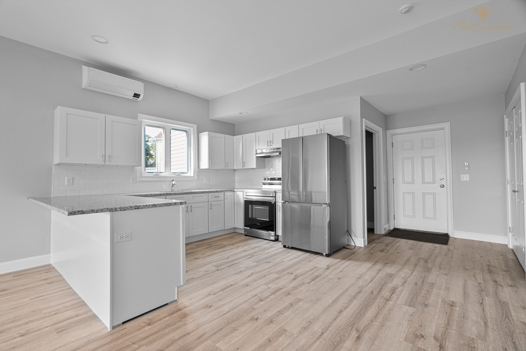 a kitchen with a refrigerator sink and cabinets