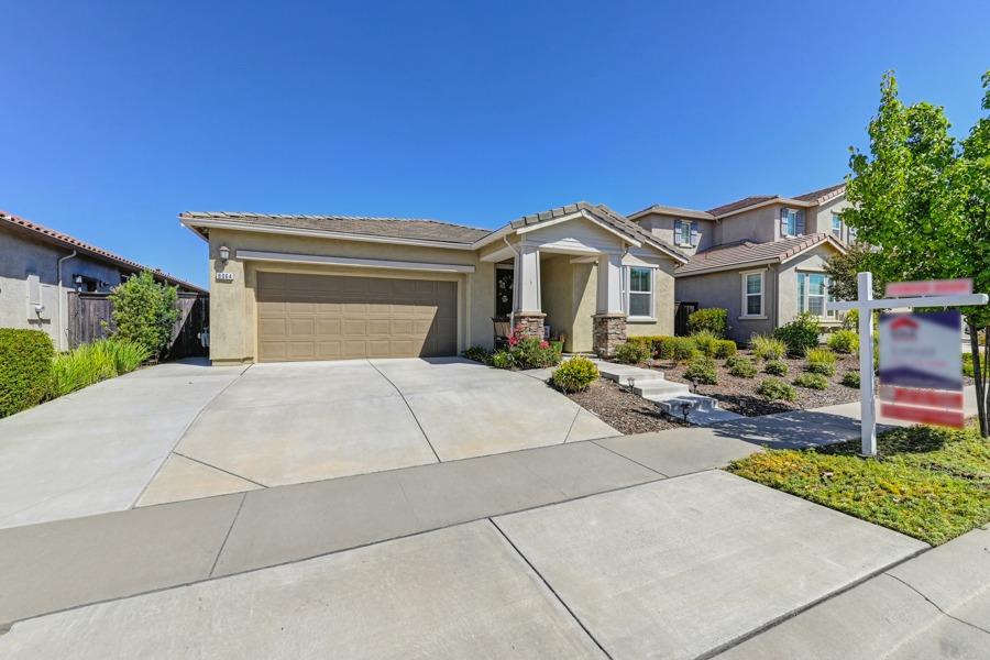 a front view of a house with a garden