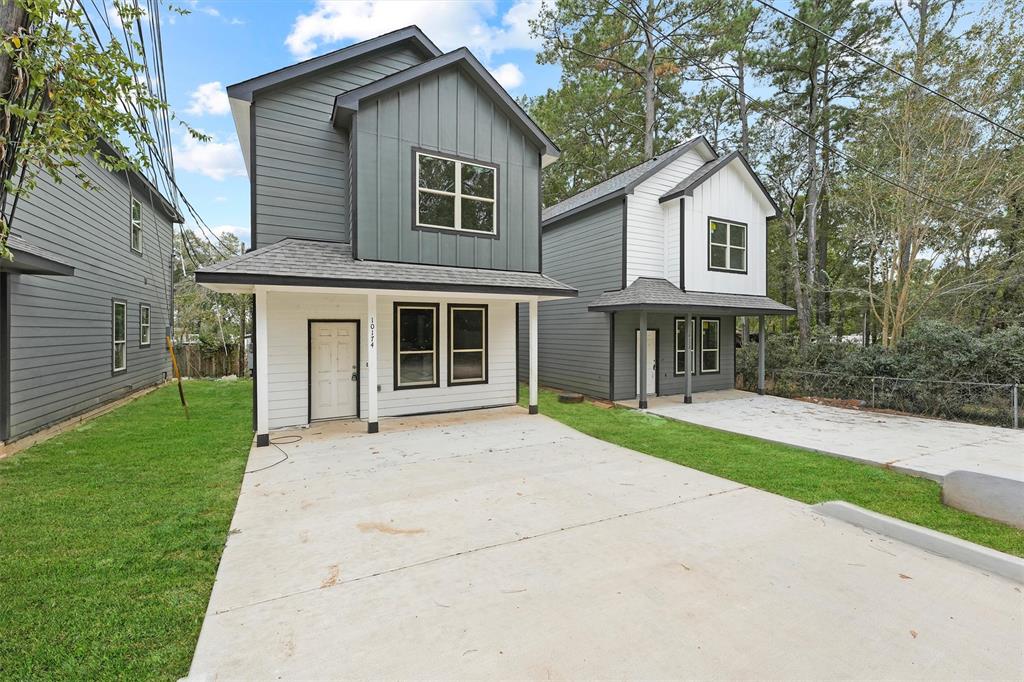 a front view of a house with a garden and yard