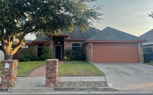 Single story home with a front lawn and a garage