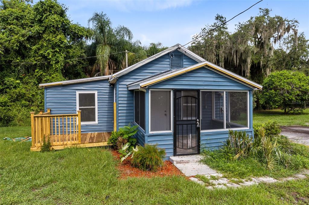 a front view of a house with a yard and porch