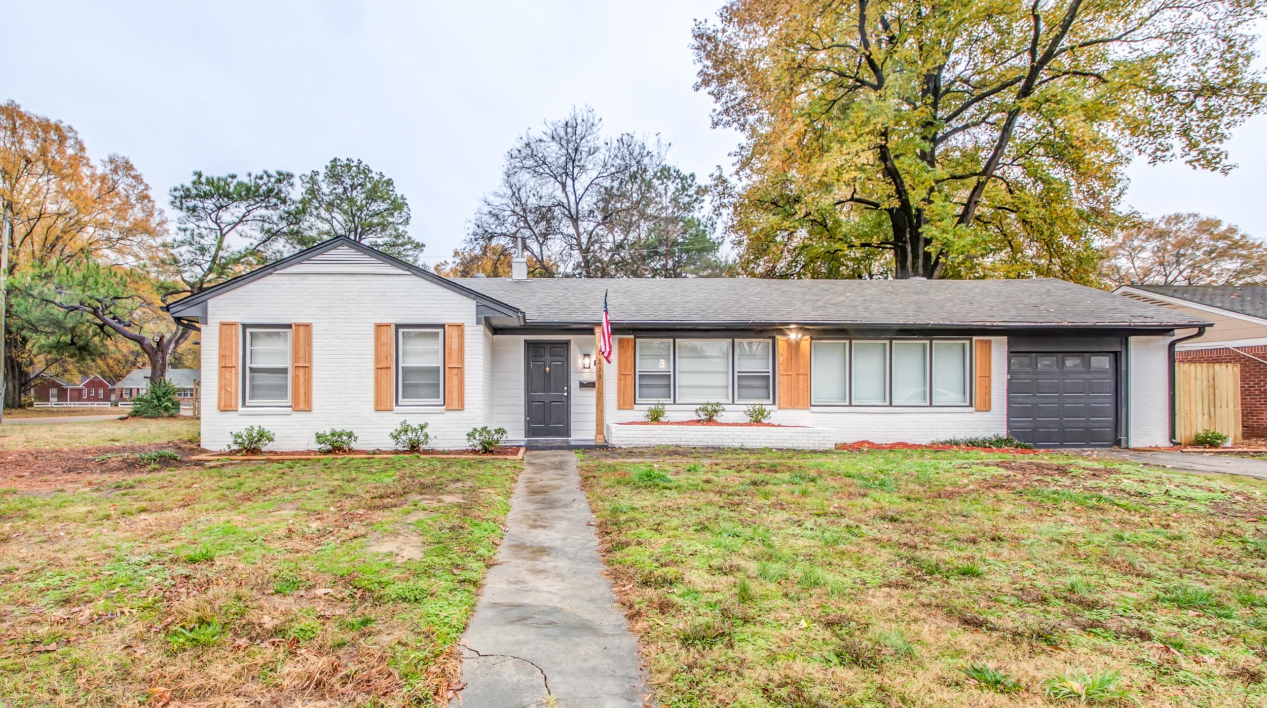 Ranch-style home featuring a garage and a front yard