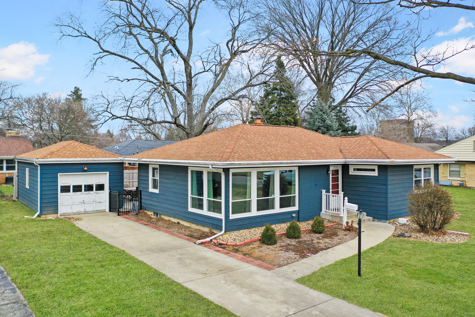 a house that has a tree in front of a house