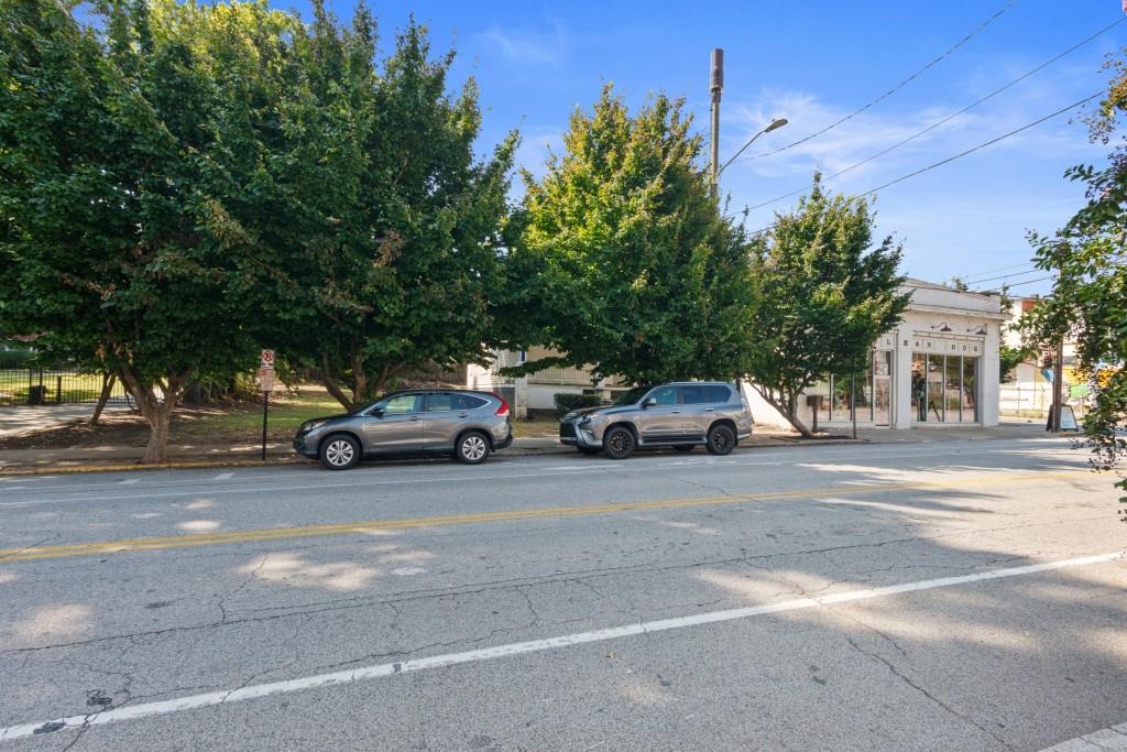 a view of a cars parked on the side of a street