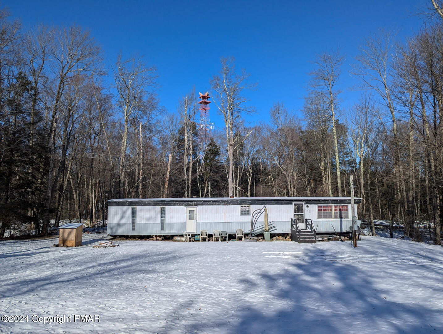 a view of a house with snow on the road