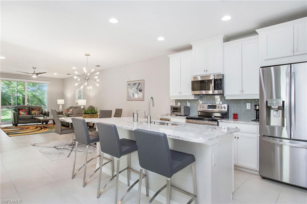 a kitchen with a sink a counter top stainless steel appliances and cabinets